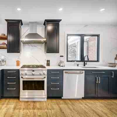 Lightbox Thumbnail stylish-new-jersey-kitchen-remodel-showcasing-black-cabinets-wood-floors-and-a-white-countertop