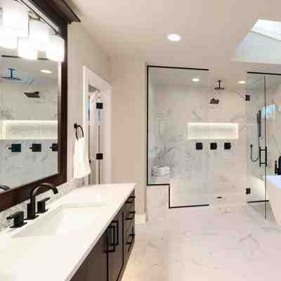 Sleek and contemporary bathroom remodel in new jersey with black vanities and white countertops