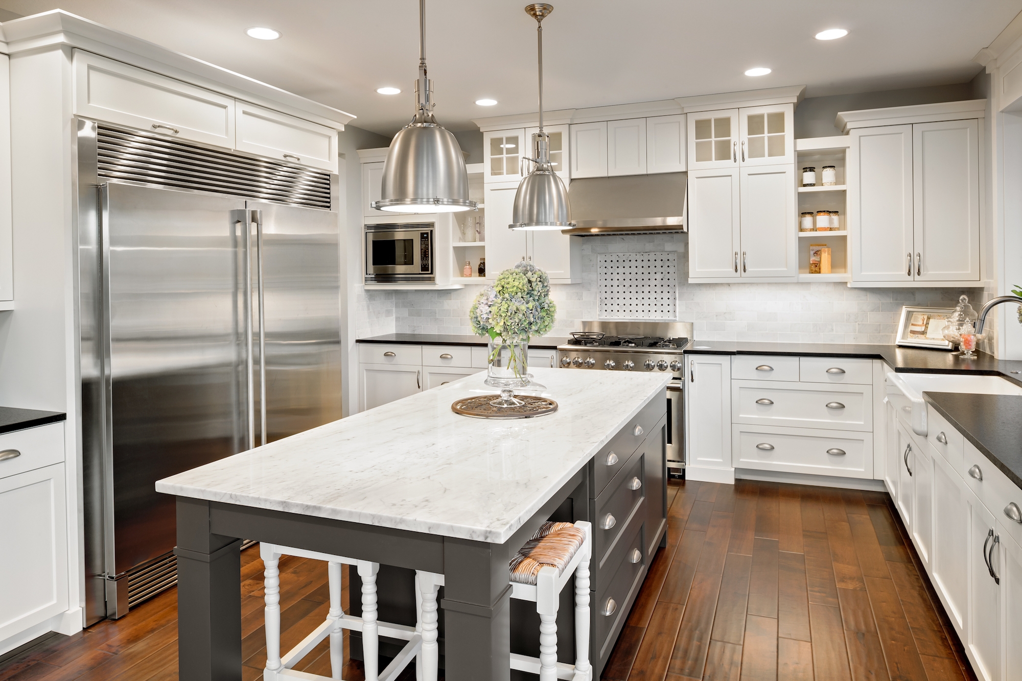 Elegant white cabinet kitchen with wood floors in a new jersey home remodel