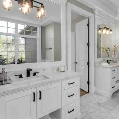 Sophisticated bathroom makeover in new jersey with white vanity and elegant lighting