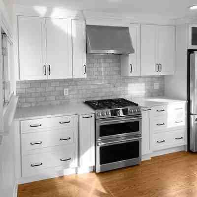 Lightbox Thumbnail spacious-kitchen-with-white-cabinets-and-wooden-floor-after-remodeling-in-nj