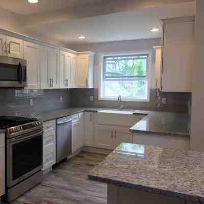 Nj kitchen remodel featuring white cabinets and wood flooring