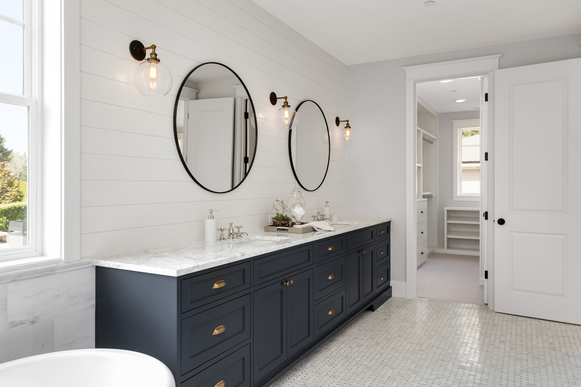 Elegant new jersey bathroom remodel with white marble flooring and black vanity