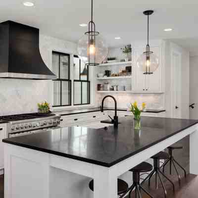 New jersey kitchen remodel with white cabinets wood floors and a contrasting black island