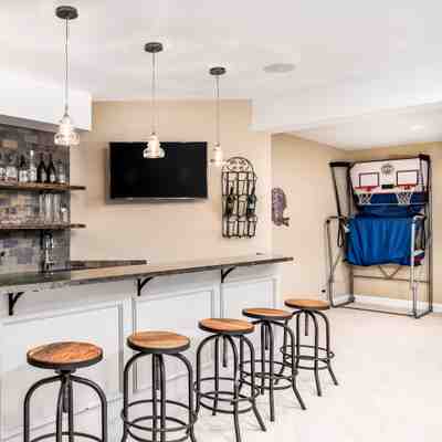 Wet bar with sleek countertops and modern fixtures for a sophisticated entertainment space in New Jersey homes